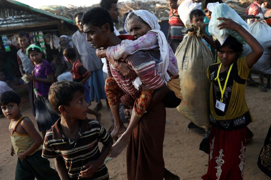 Rohingya refugee Suray Khatun, 70, is carried by her son Said-A-Lam, 38, as they enter Kutupalong refugee camp, near Cox's Bazar, Bangladesh a day after crossing the Myanmar border. Reuters/Files