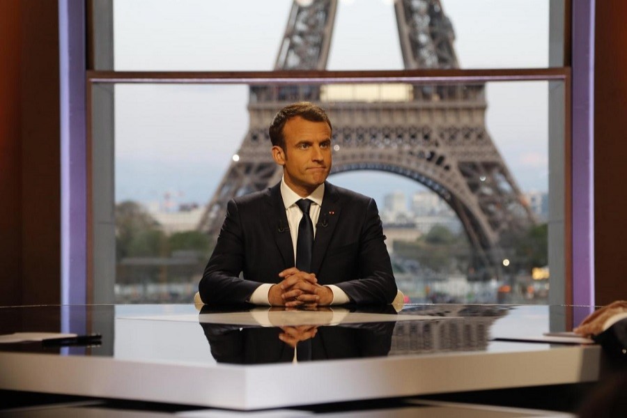 French President Emmanuel Macron poses on the TV set before an interview with RMC-BFM and Mediapart French journalists at the Theatre National de Chaillot in Paris, France, April 15, 2018. Reuters