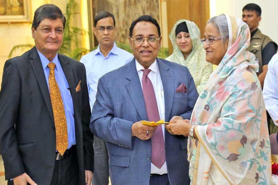 Director of Eastern Bank Limited (EBL) Mir Nasir Hossain handing over a cheque to Prime Minister Sheikh Hasina for the Prime Minister’s Relief Fund at Gonobhaban in the city recently