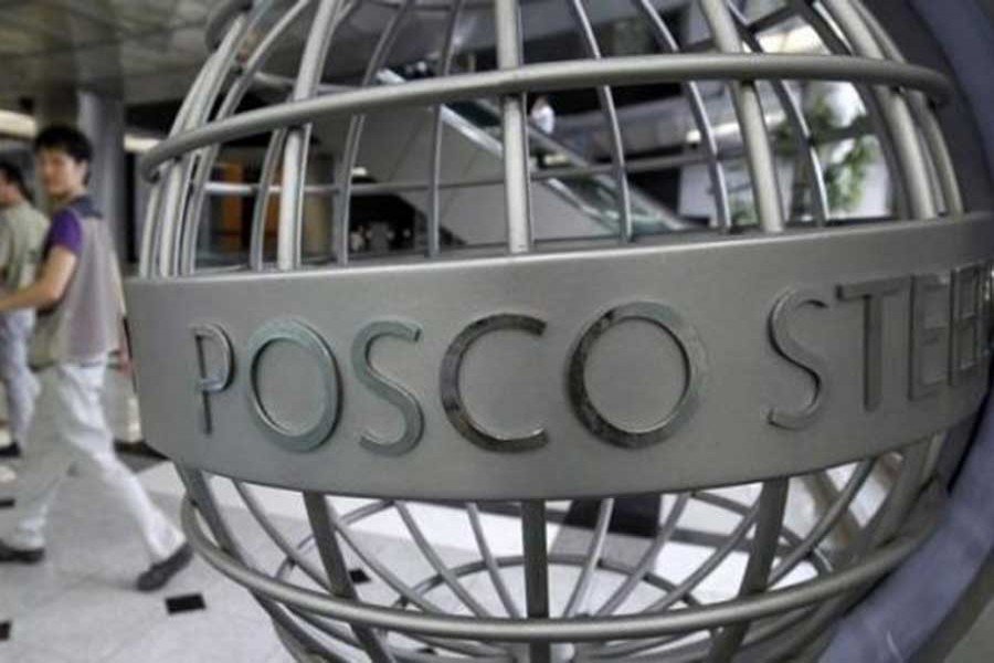 People walk past a POSCO logo at the company's headquarters in Seoul August 30, 2010. Reuters/File Photo