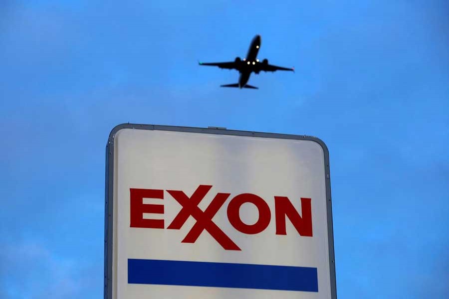 An airplane comes in for a landing above an Exxon sign at a gas station in the Chicago suburb of Norridge, Illinois, US recently    Photo: Reuters