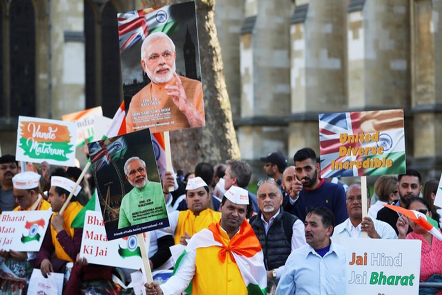 Demonstrators holding placards and pictures of India's Prime Minister Narendra Modi at Parliament Square in London on Wednesday	— Reuters