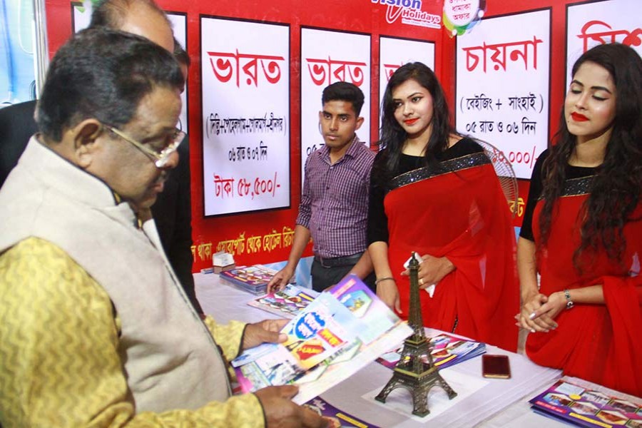 Civil Aviation and Tourism minister AKM Shahjahan Kamal visiting a stall of the fair on Thursday