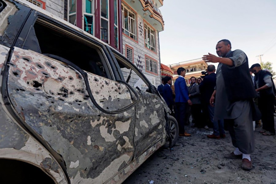 Afghan men inspect the site of a suicide bomb blast in Kabul, Afghanistan on Sunday - Reuters photo