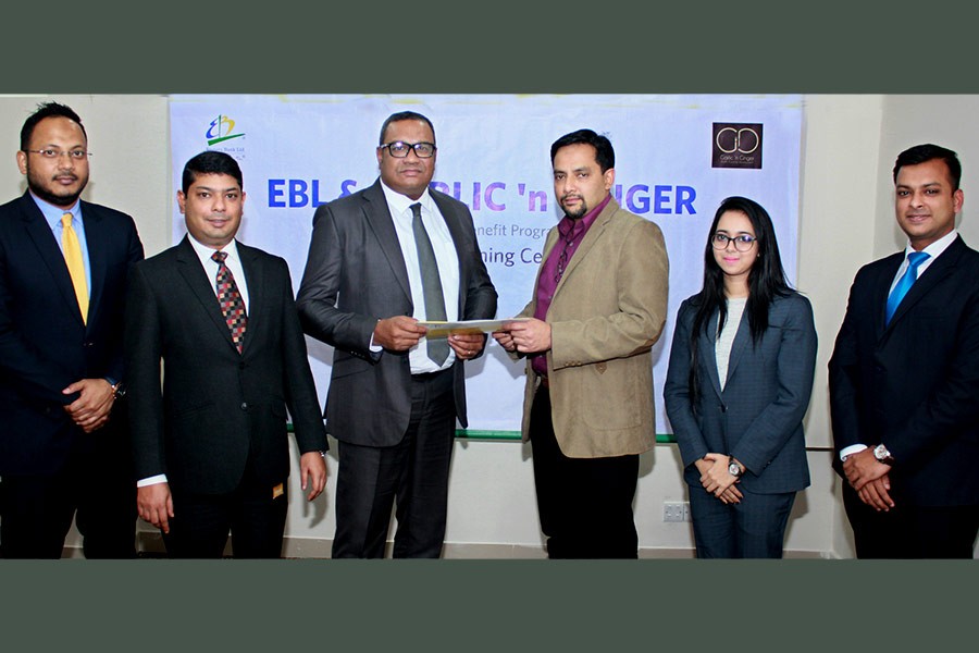 EBL's Head of Retail Banking M. Khorshed Anowar and SR Group CEO Md. Mahtabul Amin exchanging documents after signing a customer benefit agreement in Dhaka.