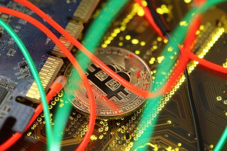 Representation of the Bitcoin virtual currency standing on the PC motherboard is seen in this illustration picture, February 3. Reuters/File