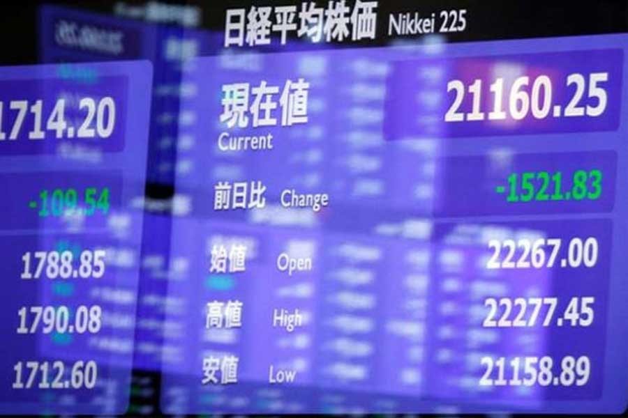 An electronic board showing the Nikkei share average is seen as market prices are reflected in a glass window at the Tokyo Stock Exchange in Tokyo, Japan, February 6, 2018. Reuters/Files