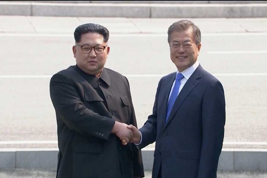North Korean leader Kim Jong Un shakes hands with South Korean President Moon Jae-in as both of them arrive for the inter-Korean summit at the truce village of Panmunjom, in this still frame taken from video, South Korea April 27, 2018. Reuters