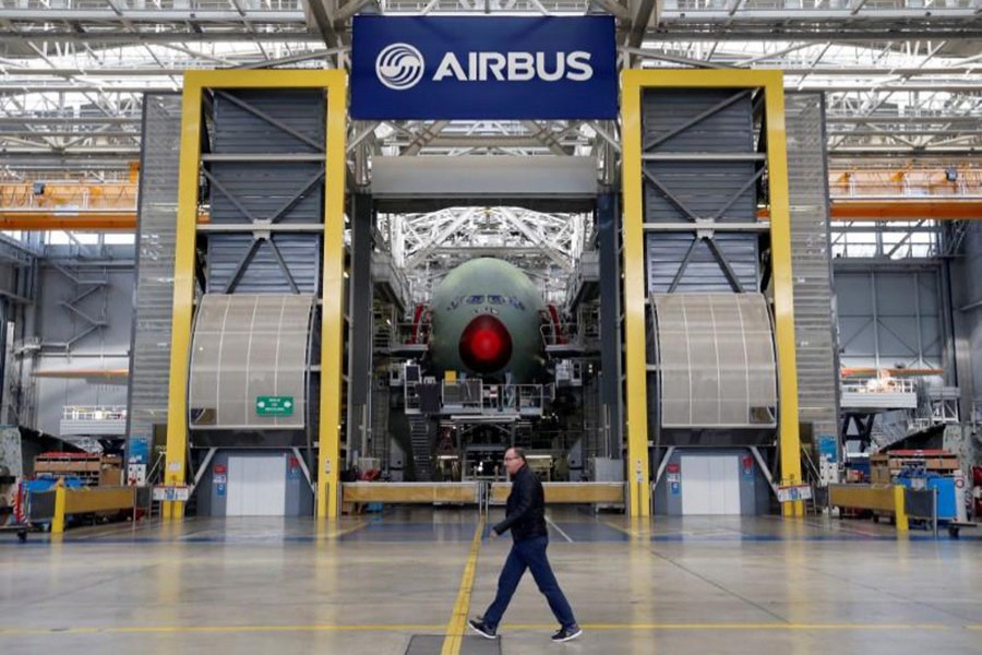An employee walks in front of an Airbus A380 at the final assembly line at Airbus headquarters in Blagnac near Toulouse, France on March 21, 2018 - Reuters photo