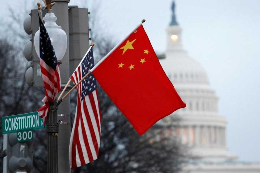 The People's Republic of China flag and the US Stars and Stripes fly on a lamp post along Pennsylvania Avenue near the US Capitol during Chinese President Hu Jintao's state visit, in Washington, DC,US, January 18, 2011. Reuters/File Photo