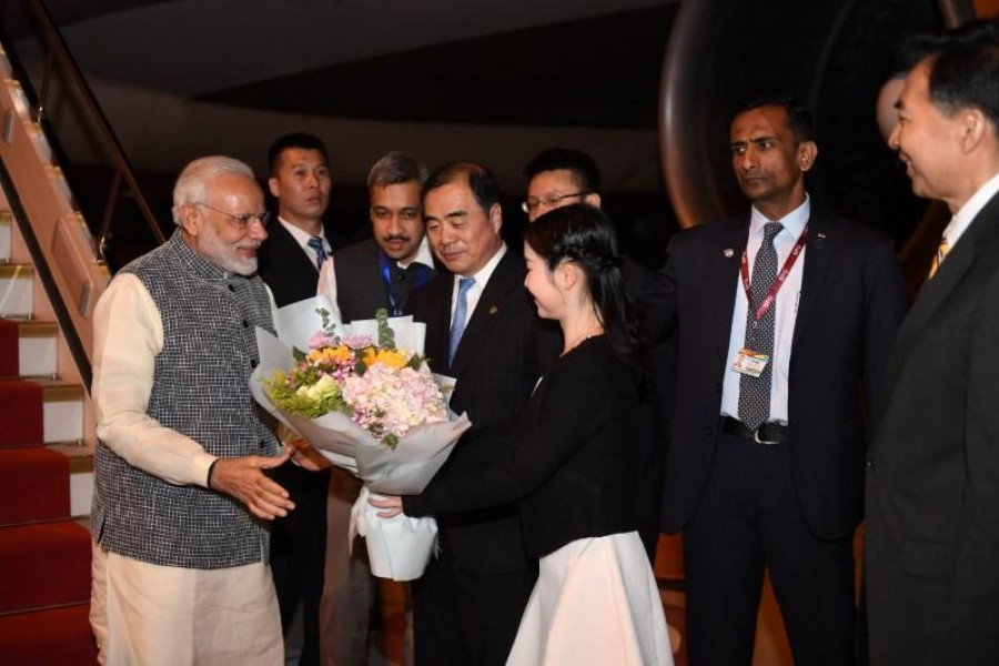 Prime Minister Narendra Modi is greeted by Chinese officials as he arrives at the airport in Wuhan, Hubei province, China early April 27, 2018. China Daily via Reuters
