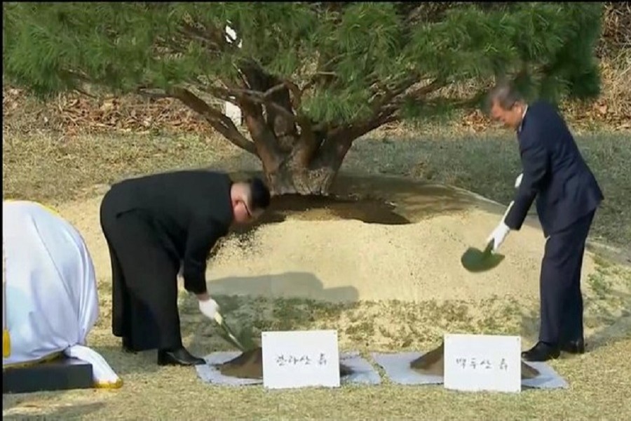 South Korean President Moon Jae-in and North Korean leader Kim Jong Un attend tree planting ceremony during the inter-Korean summit at the truce village of Panmunjom, in this still frame taken from video, South Korea April 27, 2018. Host Broadcaster via Reuters TV