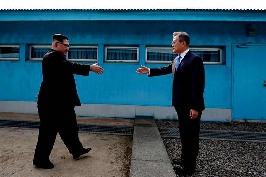 South Korean President Moon Jae-in and North Korean leader Kim Jong Un preparing to shake hands before the inter-Korean summit at the truce village of Panmunjom on Friday. -Reuters Photo