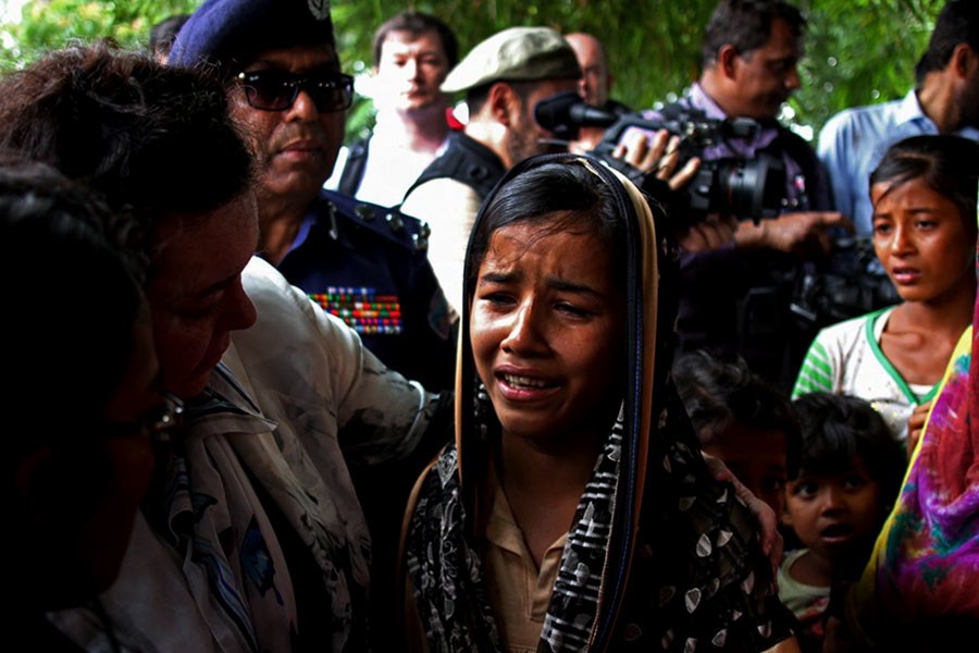 British United Nations Ambassador Karen Pierce consoling a twelve-year-old Rohingya girl near Cox’s Bazar on Sunday. -Reuters Photo