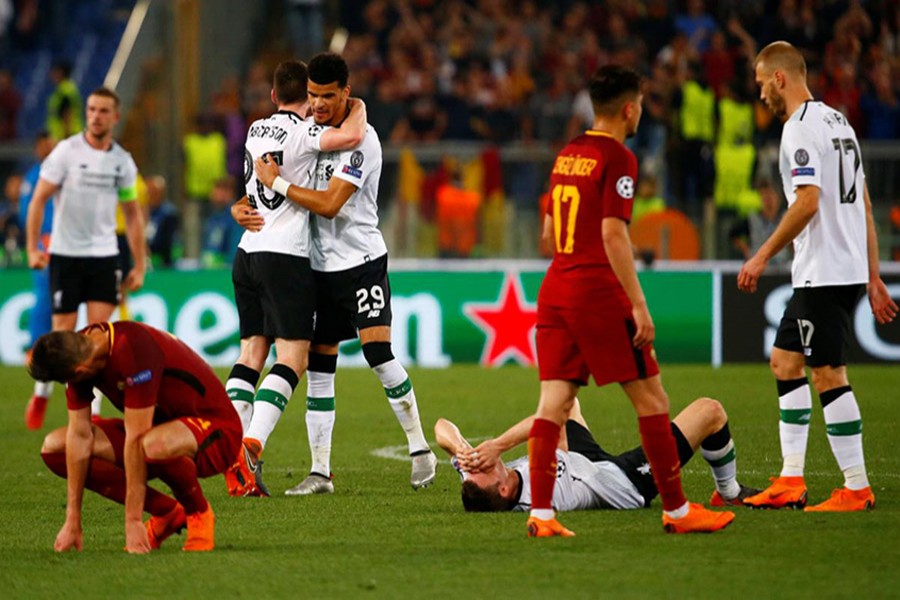 Liverpool's Dominic Solanke and Andrew Robertson celebrate as Roma players look dejected after the match on Wednesday - Reuters photo