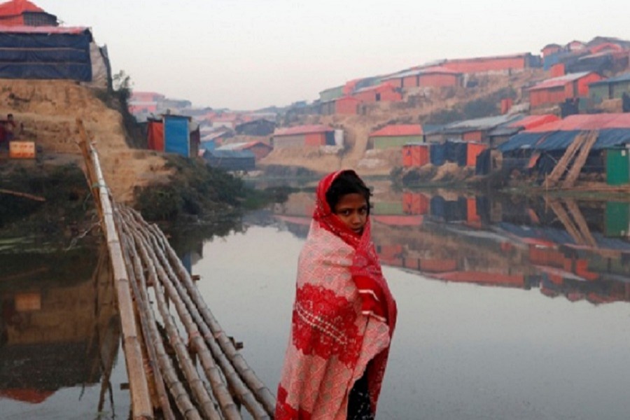 A Rohingya refugee girl walks next to a pond in the early morning at Balukhali refugee camp near Cox's Bazar, on January 10, 2018. Reuters/Files