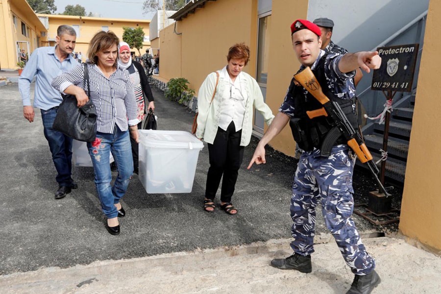 Government election officials carry ballot boxes which will be located in polling stations ahead of the country’s May 6 parliamentary election, in Beirut, Lebanon, May 5, 2018. Reuters.