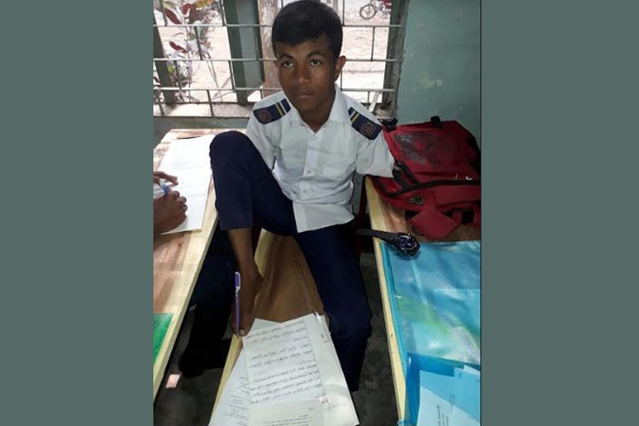 SSC examinee Sumon secured a GPA of 3.61 in his exams writing with his feet. UNB Photo