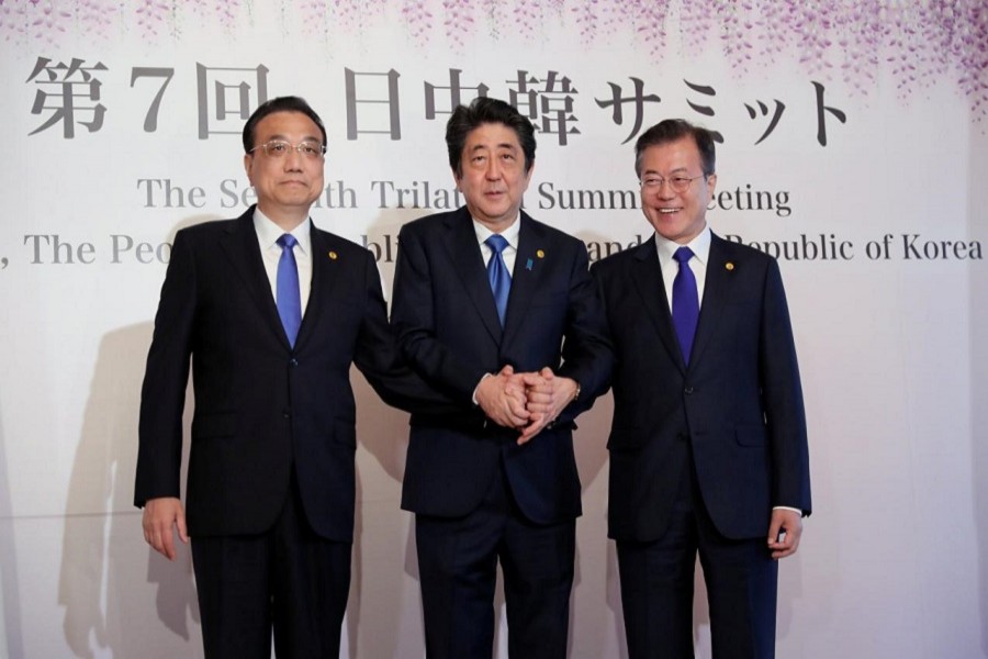 Chinese Premier Li Keqiang, Japanese Prime Minister Shinzo Abe and South Korean President Moon Jae-in pose for photographers prior to their summit in Tokyo, Wednesday, May 9, 2018. Reuters