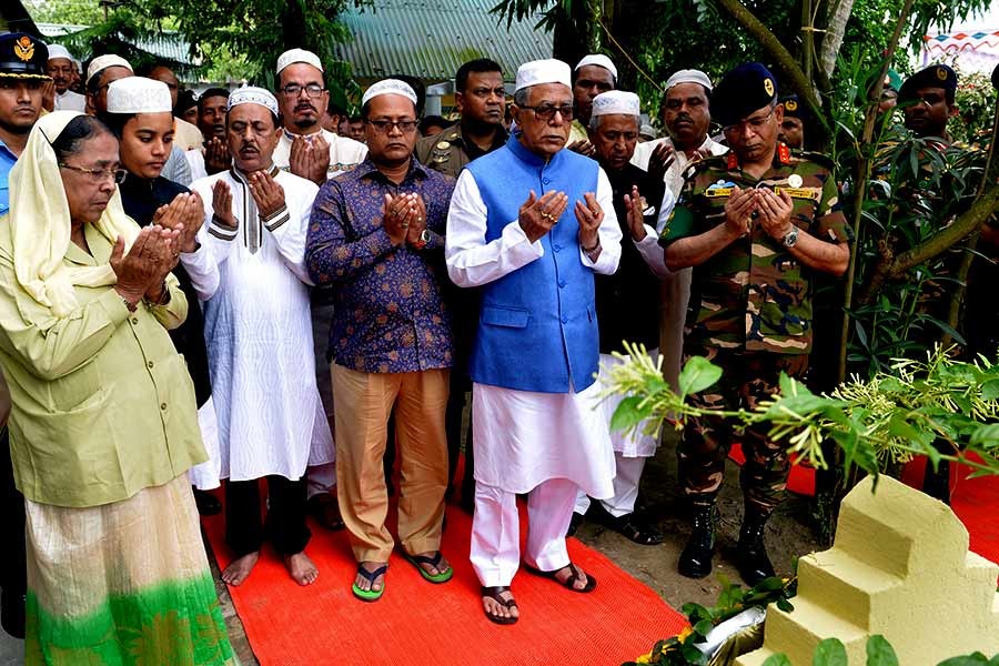 President Abdul Hamid offering fateha and doa at the graves of his father Md Tayeb Uddin and mother Tomiza Khatun and some other relatives at his ancestral village in Kishoreganj on Friday. -Focus Bangla Photo