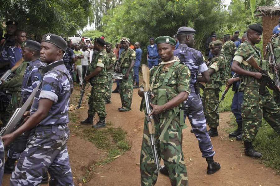 Army soldiers and policemen attend the scene where more than 20 people were killed in their homes in an overnight attack in Burundi’s northwestern province of Cibitoke late on Friday - AP photo