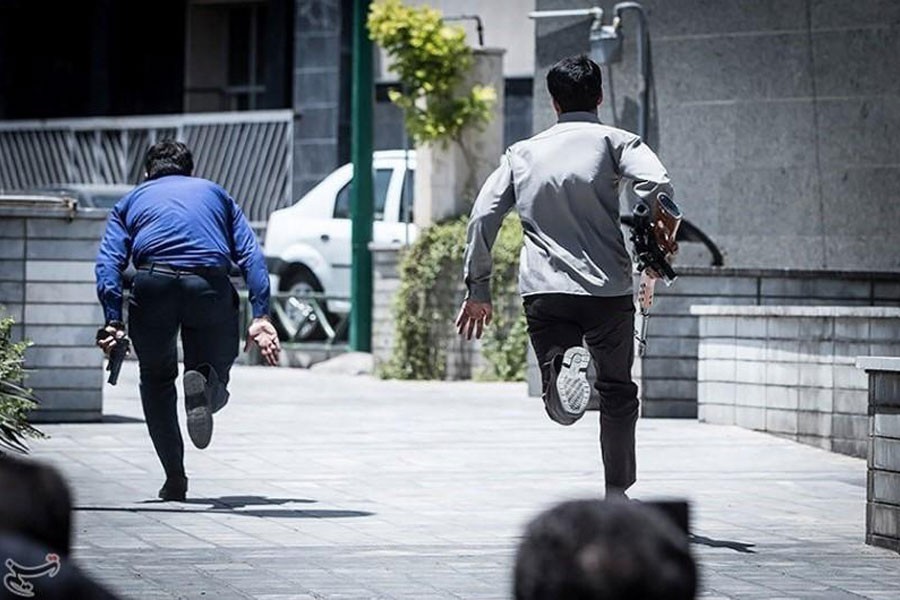 Members of Iranian forces run during an attack on the Iranian parliament in central Tehran, Iran, June 7, 2017. Tasnim News Agency via Reuters.