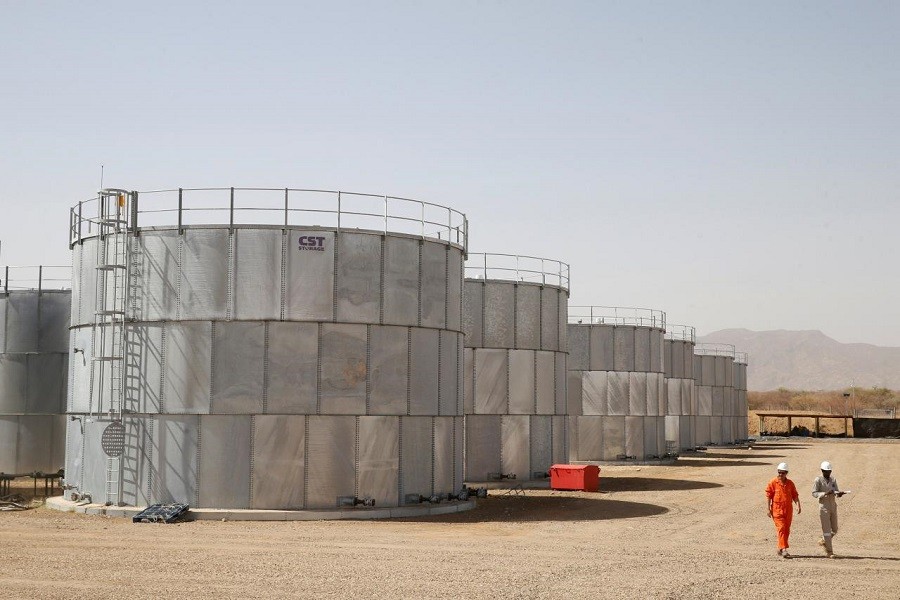 Workers walk past storage tanks at Tullow Oil's Ngamia 8 drilling site in Lokichar, Turkana County, Kenya, February 8, 2018. Reuters/File Photo