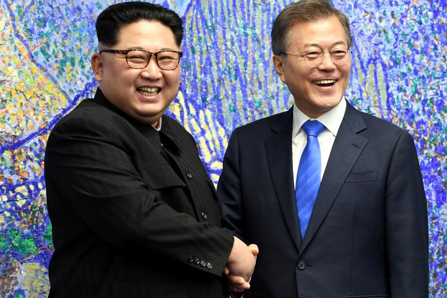 South Korean President Moon Jae-in shakes hands with North Korean leader Kim Jong Un during their meeting at the Peace House. Korea Summit Press Pool/Pool via Reuters.