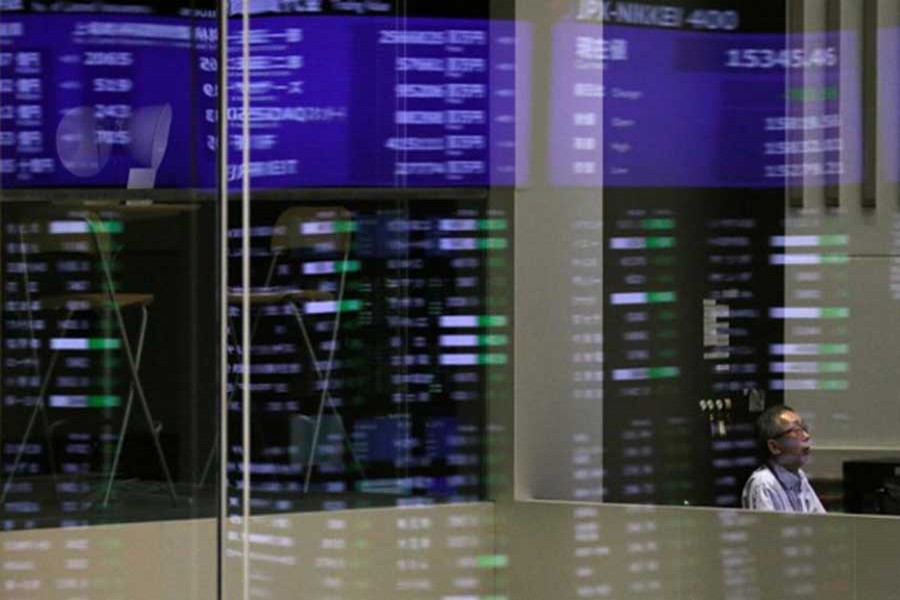 Market prices are reflected in a glass window at the Tokyo Stock Exchange (TSE) in Tokyo, Japan, February 6, 2018. Reuters/Files