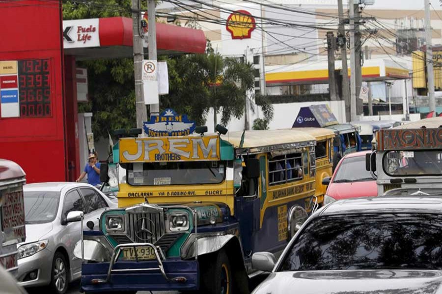 Motorists drives past an electronic board at a gas station in Paranaque city, Metro Manila, the Philippines February 4, 2016. Reuters/File Photo