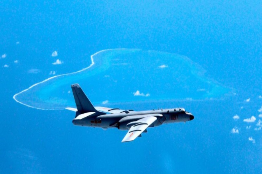 In this file photo, a Chinese H-6K bomber patrols the islands and reefs in the South China Sea. The China Daily newspaper reported Saturday, May 19, 2018 that People's Liberation Army Air Force conducted takeoff and landing training with the H-6K bomber in the South China Sea. - Liu Rui/Xinhua via AP