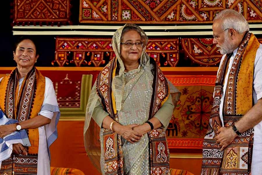 Indian Prime Minister Narendra Modi speaks with Prime Minister Sheikh Hasina as West Bengal chief minister Mamata Banerjee looks on, during the annual convocation of Visva Bharati University, in India, on May 25. - PTI Photo