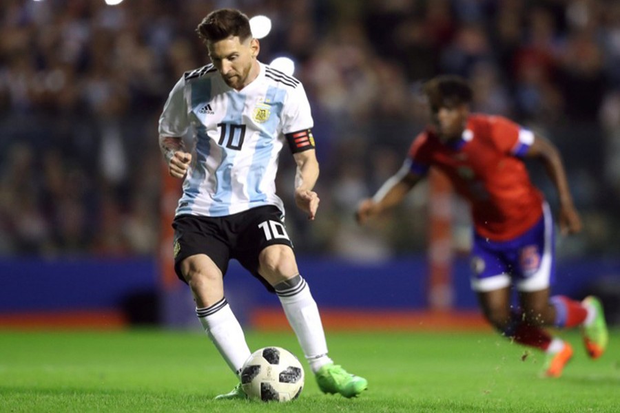 Argentina's Lionel Messi scores their first goal from the penalty spot against Haiti on Tuesday - Reuters photo