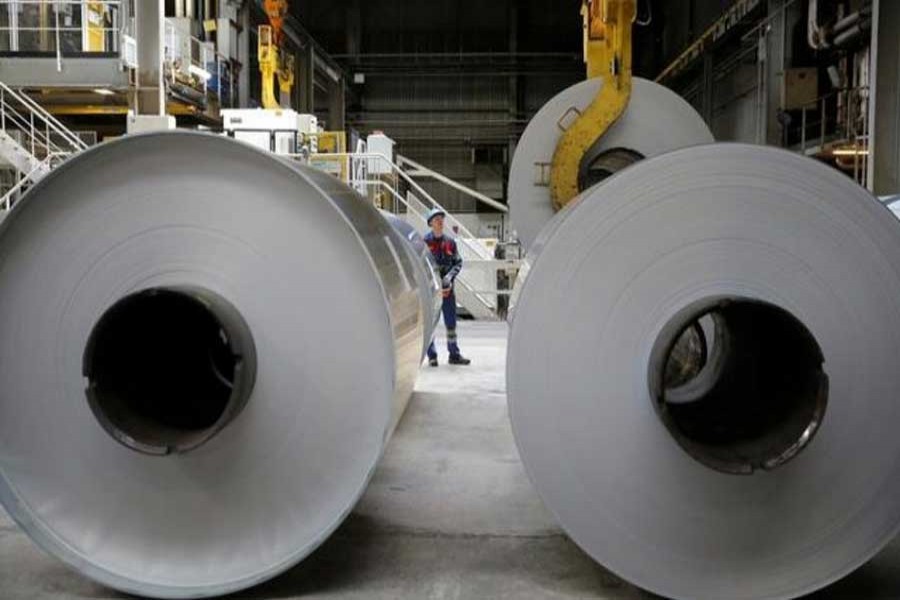 An operator uses a hoist to lift a coil of aluminium at the Neuf-Brisach Constellium aluminium products company's production unit in Biesheim, Eastern France, April 9, 2018. Reuters/Files