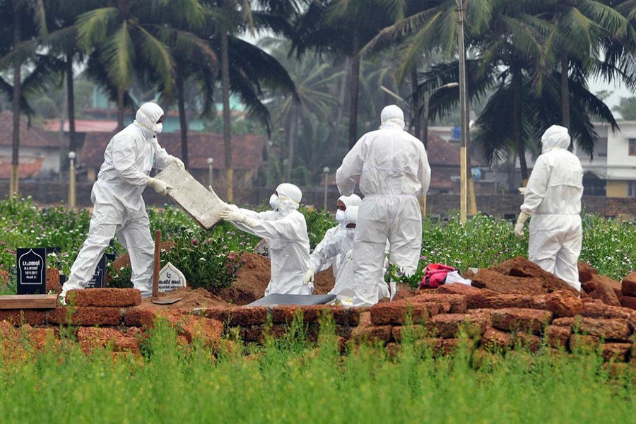 Doctors and relatives wearing protective gear dig a grave to bury the body of a victim, who lost his battle against the brain-damaging Nipah virus, at a burial ground in Kozhikode, in the southern Indian state of Kerala, India on May 24 last - Reuters