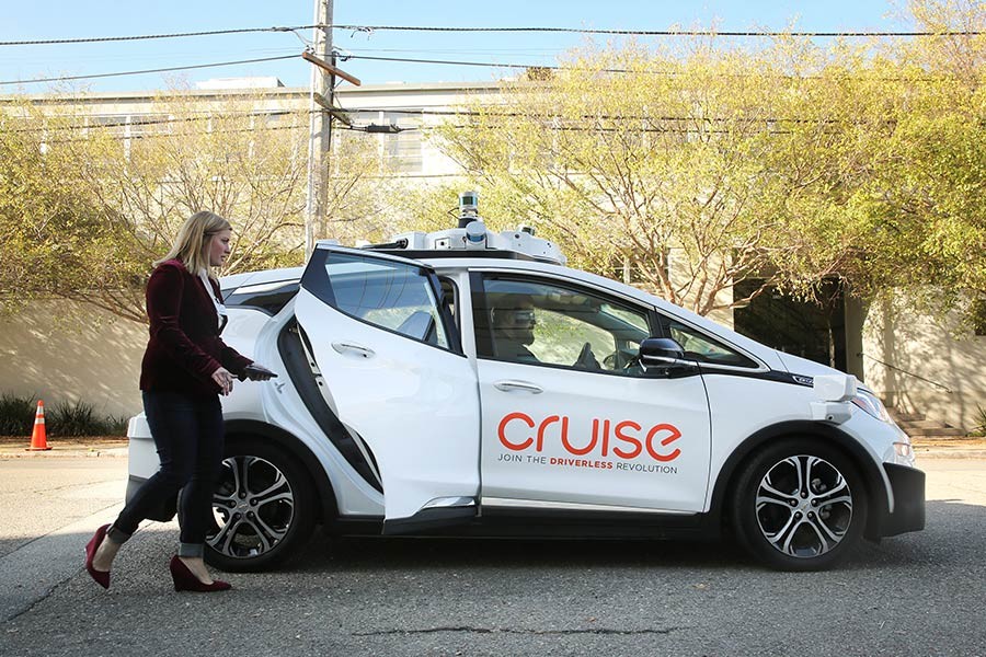 A woman gets in a self-driving Chevy Bolt EV car during a media event by Cruise, GM's autonomous car unit, in San Francisco, California, US on November 28, 2017 - Reuters/File