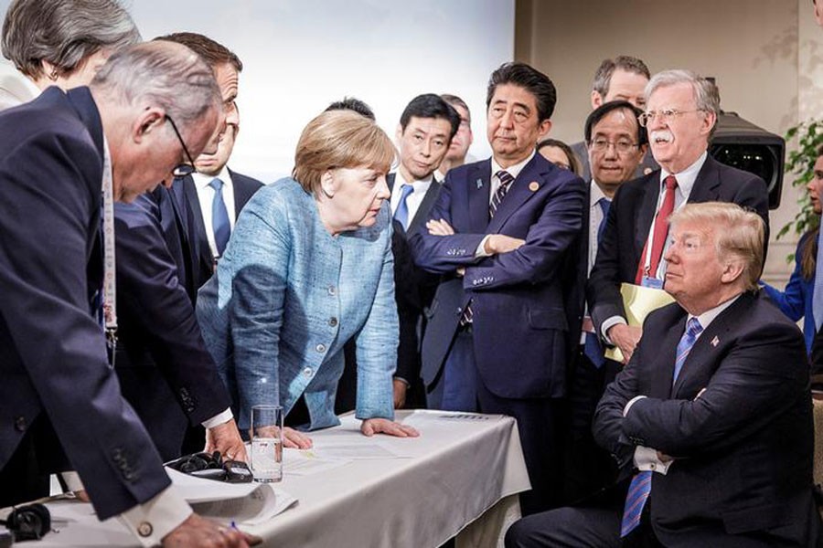 German Chancellor Angela Merkel speaks to US President Donald Trump during the second day of the G7 meeting in Charlevoix city of La Malbaie, Quebec, Canada, June 9, 2018. Reuters