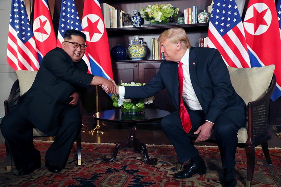 US President Donald Trump shakes hands with North Korea's leader Kim Jong Un before their bilateral meeting at the Capella Hotel on Sentosa island in Singapore on Tuesday - Reuters photo