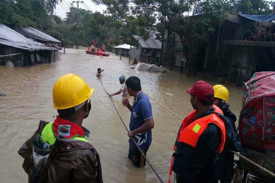 Rescue men in action in the ongoing flood. Photo: Focus Bangla