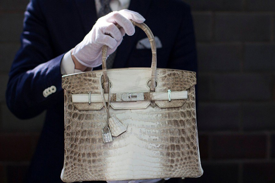 An employee holds a Hermes diamond and Himalayan Nilo Crocodile Birkin handbag - Reuters file photo