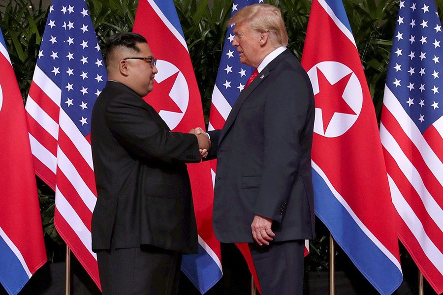 US President Donald Trump shakes hands with North Korean leader Kim Jong Un at the Capella Hotel on Sentosa island in Singapore on Tuesday - Reuters photo