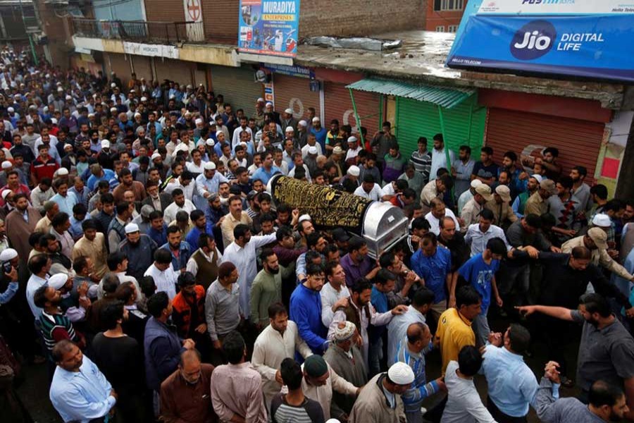 People carry the body of Syed Shujaat Bukhari, the editor-in-chief of local newspaper "Rising Kashmir", who according to local media was killed by unidentified gunmen outside his office in Srinagar, during his funeral in Kreeri, north of Srinagar, June 15, 2018. Reuters