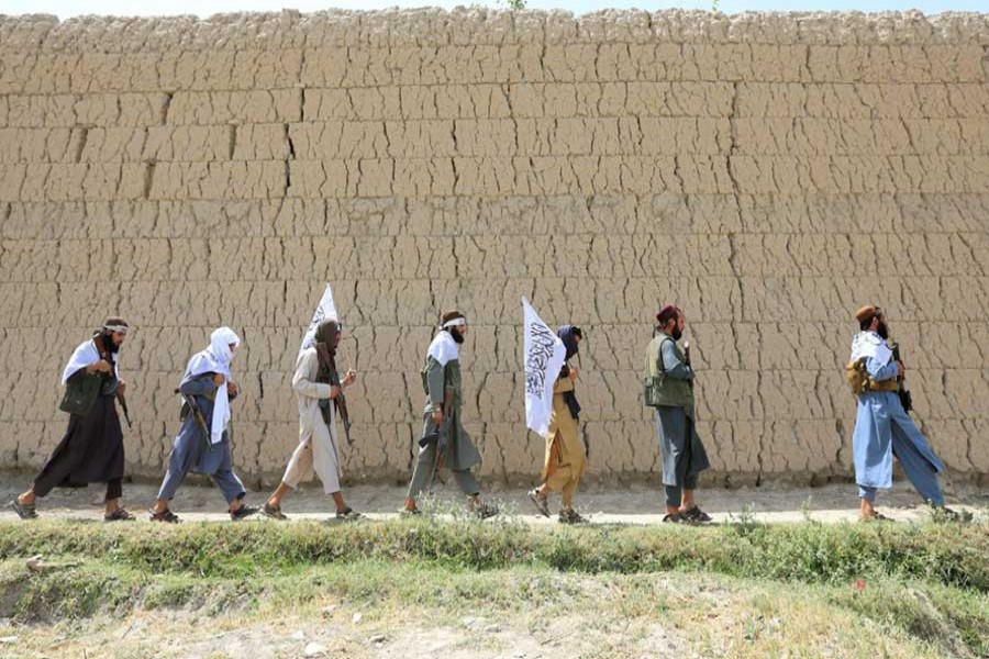 Taliban walk as they celebrate ceasefire in Ghanikhel district of Nangarhar province, Afghanistan, June 16, 2018. Reuters