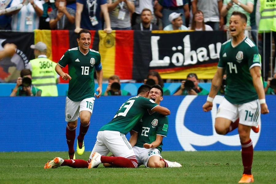 Mexico's Hirving Lozano celebrates with Jesus Gallardo after scoring their first goal against Germany on Sunday. -Reuters Photo