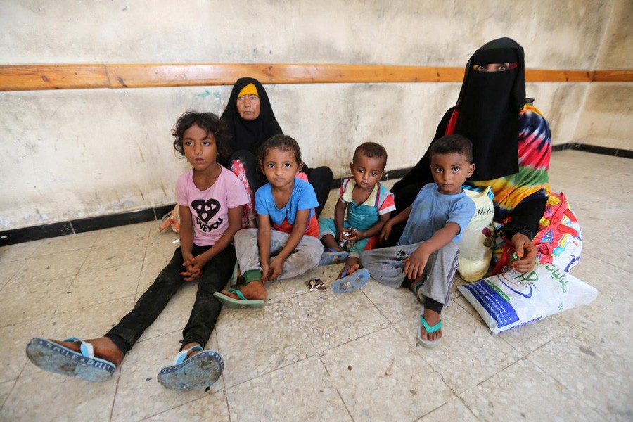 Family members sitting  in a classroom of a school where they have been evacuated from a village near Hodeidah airport  in Yemen on Monday	— Reuters