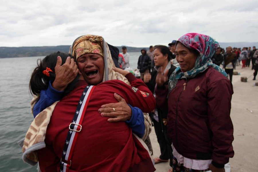 Relatives cry while waiting for news on missing family members who were on a ferry that sank on Monday in Lake Toba, at Tigaras Port, Simalungun, North Sumatra, Indonesia June 19. Reuters/File