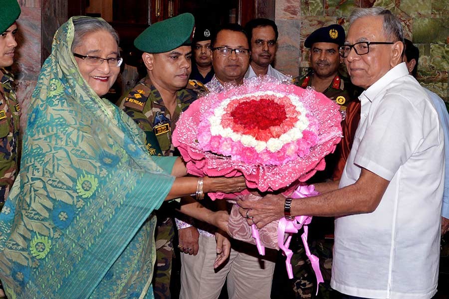 President Abdul Hamid receiving Prime Minister Sheikh Hasina with a bouquet of flower after her arrival at Bangabhaban on Tuesday evening. -Focus Bangla Photo