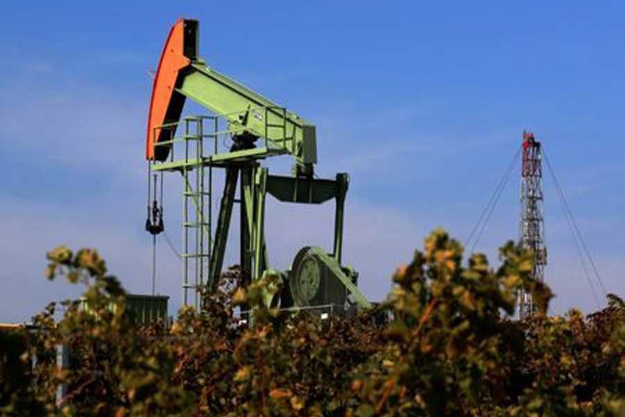 A pumpjack is seen behind a vineyard near Zistersdorf, Austria, October 2, 2017. Reuters/Files