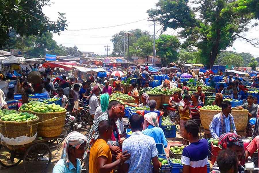 Traders thronging the Baneswar Haat, the largest mango market in the country, in Rajshahi on Thursday     	— FE Photo