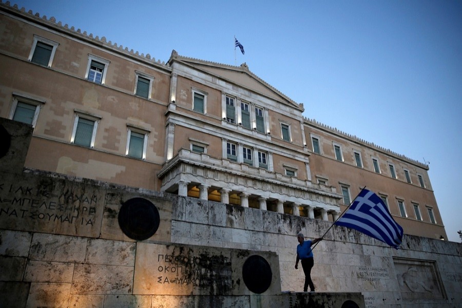 A man waves a Greek flag during an anti-government rally outside the Greek parliament building in Athens, Greece, June 20, 2017. Reuters/File Photo